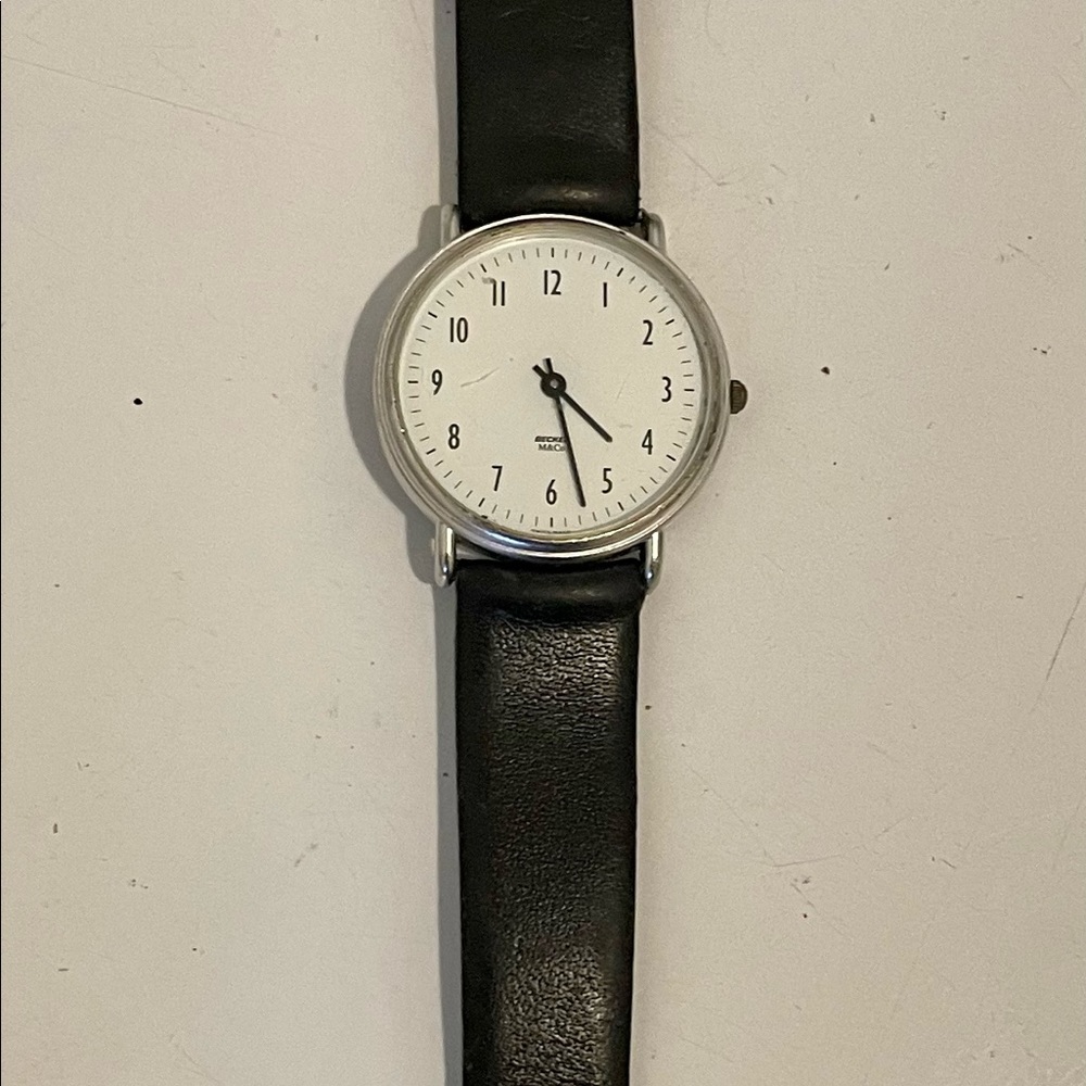 Women’s M&Co watch with black leather band.